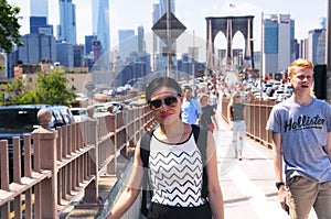 Tourists on the Brooklyn bridge and New York City Skyline daytime