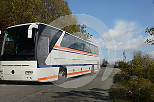 Tourists bus on narrowed mountain high way.