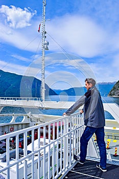 Tourists and cars on a ferry boat, crossing the Sognefjord in Norway