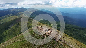 Tourists climb to the top of the mountain Hoverla aerial panorama view