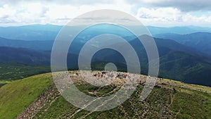 Tourists climb to the top of the mountain Hoverla aerial panorama view