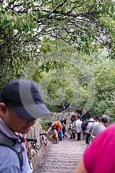 Tourists on steep mountain trail in Huashan mountain