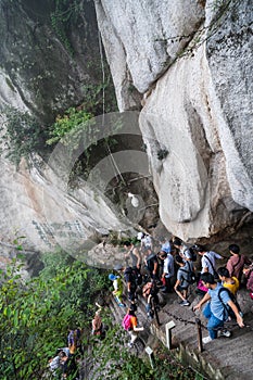 Tourists on steep mountain trail in Huashan mountain