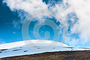 Tourists climbs for camping to the snow-capped mountain top. Con