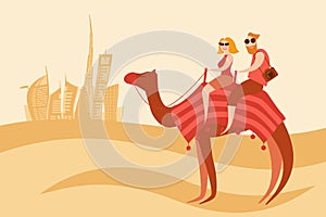 Tourists couple camel riders in the desert near Dubai city