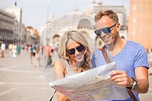 Tourists couple looking at city map