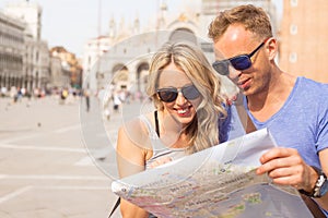 Tourists couple looking at city map