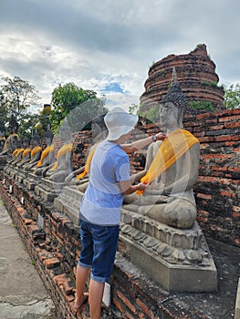 Tourists cover the Buddha image It is a merit-making according to the beliefs of Buddhists