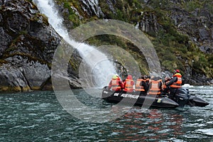 Tourists from the cruise ship near the waterfalls of the glacier Nena.