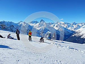 Tourists in Dombay - a downhill skiing resort in Karachayevo-Cherkesiya, Russia. At an altitude 3200 metres.