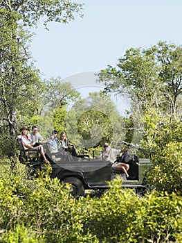 Tourists And Driver In Jeep On Safari