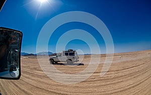 Tourists driving 4x4 in the desert