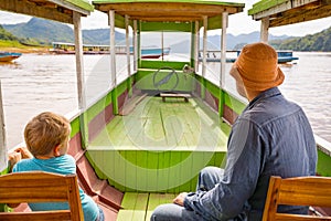 Tourists enjoy boat trip by Mekong river. Laos.