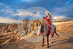 Tourists enjoy ride horses in Cappadocia, Turkey.