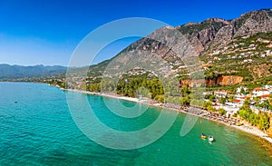 Tourists enjoy summer vacations swimming at Almyros beach in Kato verga seaside town near Kalamata, Greece