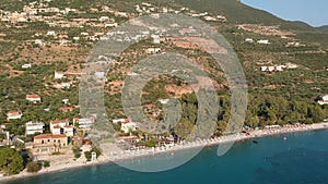 Tourists enjoy summer vacations swimming at Almyros beach in Kato verga seaside town near Kalamata, Greece