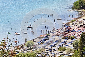 Tourists enjoy sun and watersports in the volcano lake of Castel Gandolfo