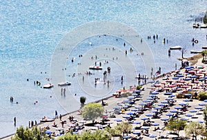 Tourists enjoy sun and watersports in the volcano lake of Castel Gandolfo