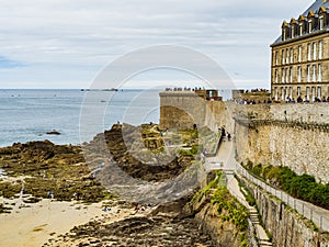 Tourists enjoying the beach surrounding the fortress of Saint Malo, Brittany, France