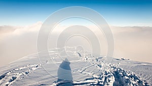 Tourists enjoying high mountains in snow on a sunny day