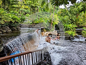 Tourists enjoying the hot springs of Tabacon in Costa Rica