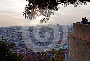 Tourists enjoying the sunset over the Historic City Centre of Lisbon from the top of Saint George Castle Castelo de SÃÂ£o Jorge