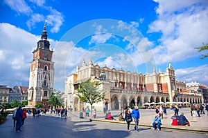 Tourists at Krakow Cloth Hall and and Town Hall Tower located in center of town square in the Krakow, Poland