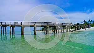 Tourists enjoying the Vanderbilt beach in Naples, Florida.