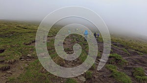 Tourists in the fog climb Hoverla, Ukraine,