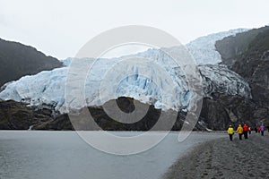 Tourists at the foot of the Aguila glacier. Tierra Del Fuego