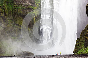 Tourists in front of Skogafoss waterfall