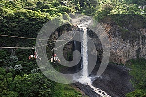 Tourists gliding on the zip line trip, Cascades route, Banos, Ecuador photo