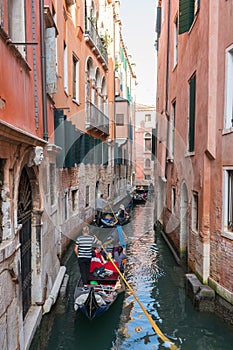 Tourists on Gondola on the canals of Venice, Italy