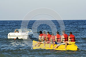 Tourists having fun with banana at the seaside