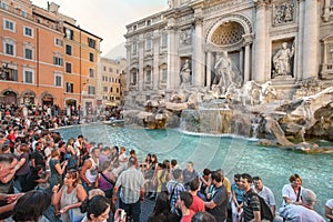 Tourists having fun by Trevi Fountain in Rome