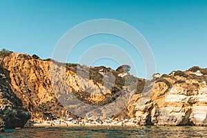 Tourists Having Fun In Water, Relaxing And Sunbathing On Praia do Camilo Camel Beach At Lagos In Portugal