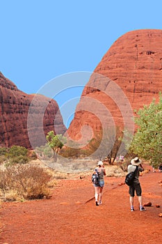 Couple is hiking in the Olgas mountains, Nothern Territory, Australia