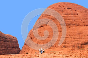 Tourists are hiking along the Olgas mountains,Northern Territory,Australia