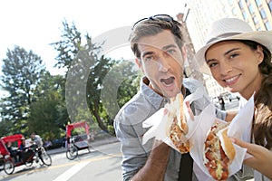 Tourists with hot dog in new york