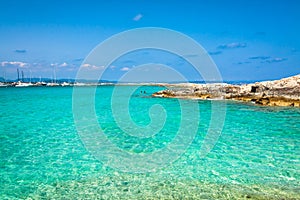 Tourists in Illetes beach Formentera island, Mediterranean sea,