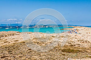 Tourists in Illetes beach Formentera island, Mediterranean sea,