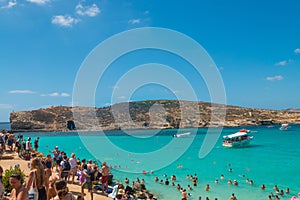 Tourists ist swimming at Blue Lagoon, Comino, Malta