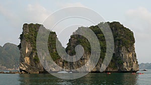 Tourists in kayaks or canoes exploring the caves and limestone islands of Ha Long Bay, Vietnam