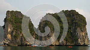 Tourists in kayaks or canoes exploring Ha Long Bay, Cat Ba National Park, Vietnam