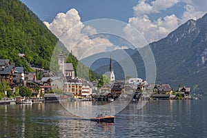 Tourists lake cruise boat on Hallstattersee by the World Heritage lakeside town in the Alps, Hallstatt, Salzkammergut, Austria