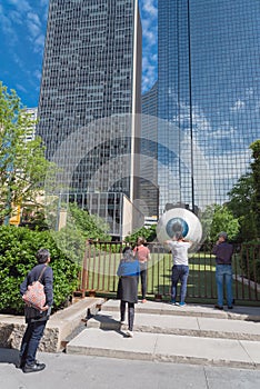 Tourists and local resident taking photo with Giant Eyeball in downtown Dallas, Texas