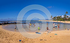 Tourists and locals enjoy Poipu Beach, Kauai