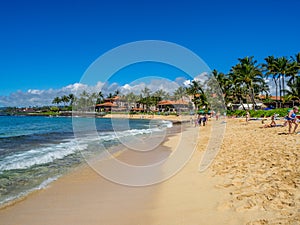 Tourists and locals enjoy Poipu Beach, Kauai