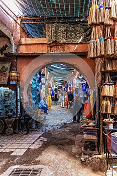 Tourists and locals walking through the souks in the old medina of Marrakech