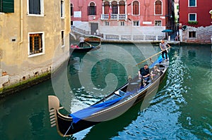 Tourists make gondola ride on canals of Venice, Italy